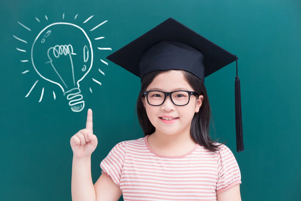 A child smiling in a graduation cap